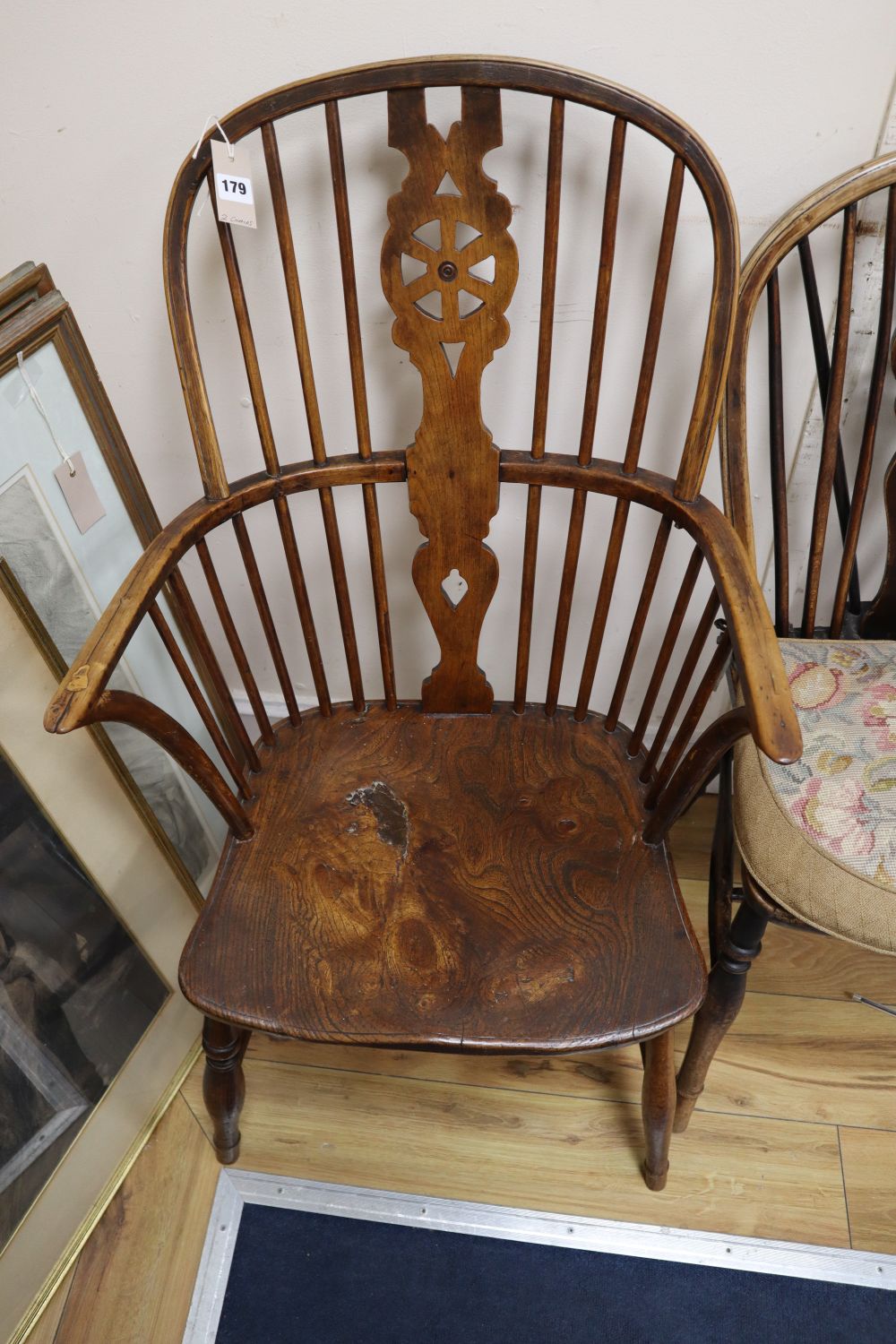 A 19th century ash, beech and elm Windsor wheelback armchair and a Windsor wheelback single chair